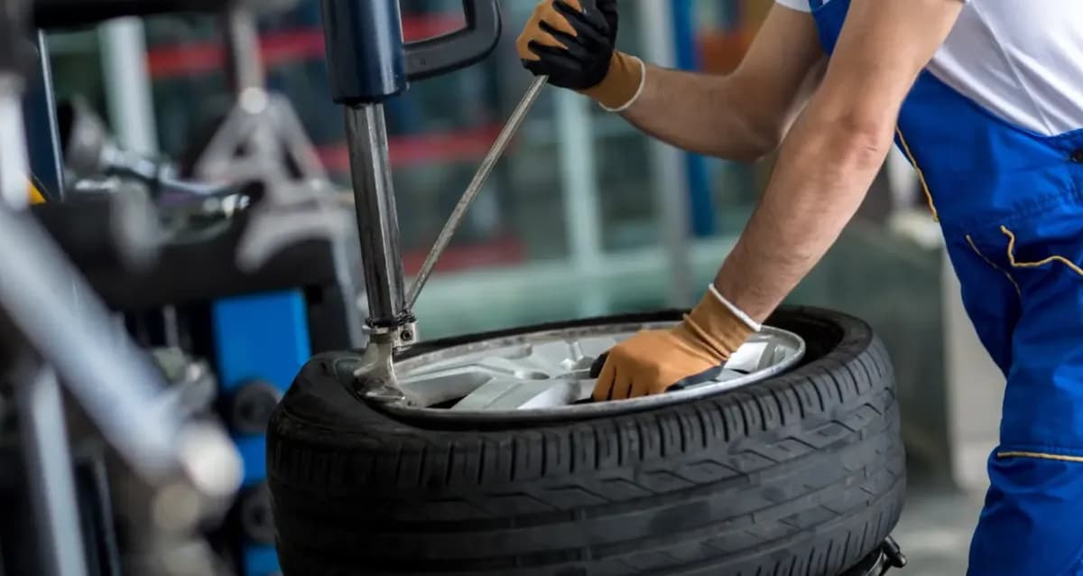 A tyre being fitted to an alloy wheel on a tyre-changing machine